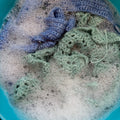 Crochet pieces in foamy water