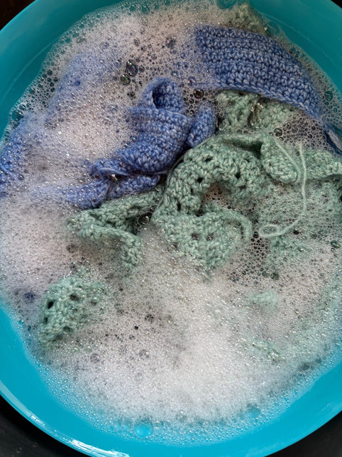 Crochet pieces in foamy water