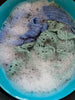 Crochet pieces in foamy water