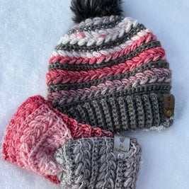 One crochet hats with pom-pom and a headband on a snowy background