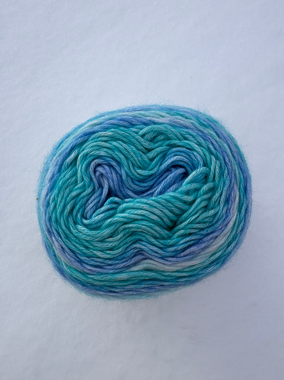Blue and green skein of yarn on a white background