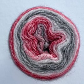 Spool of multicolored yarn on a light gray background