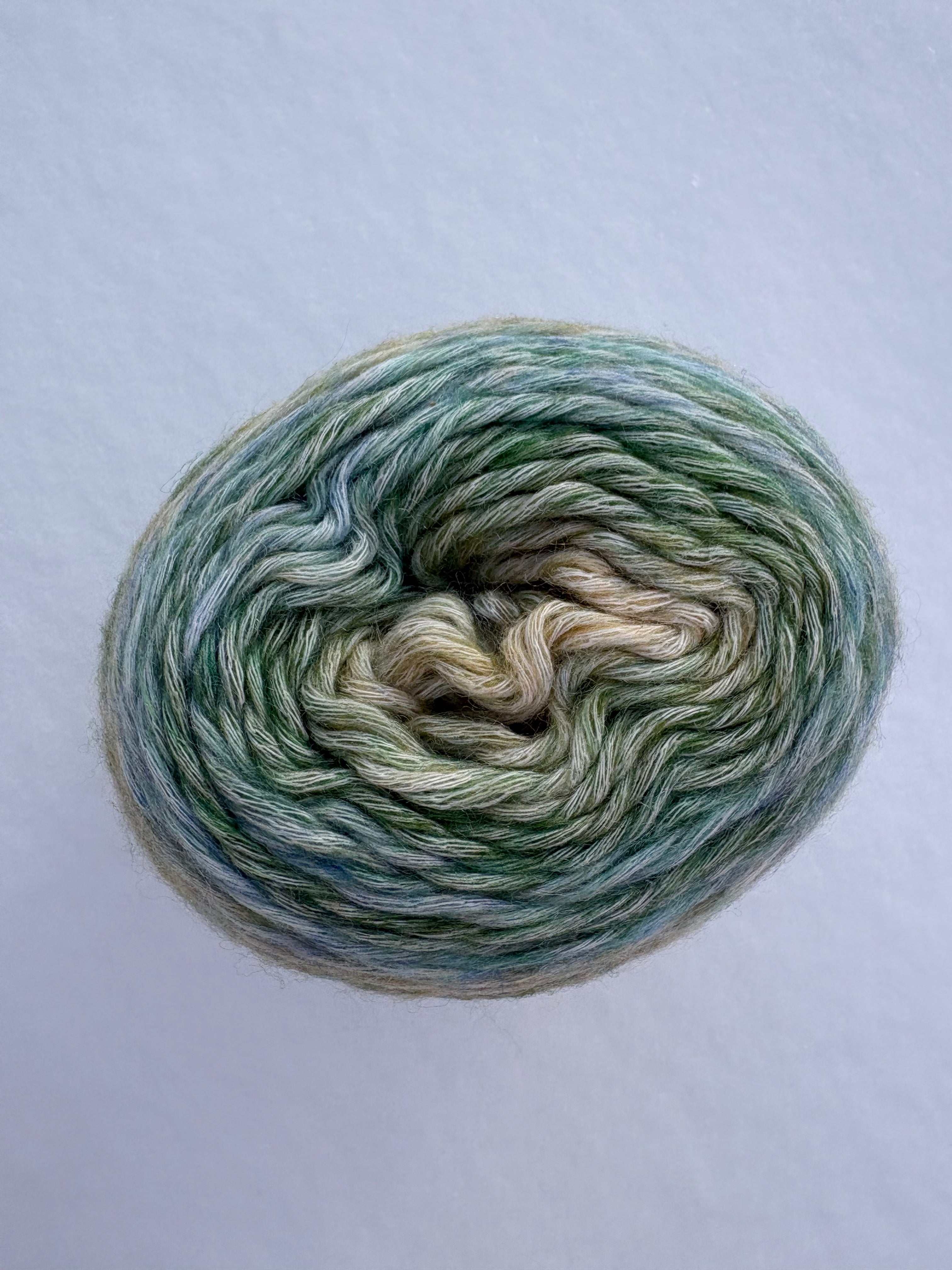 Multicolored yarn skein on a light gray background