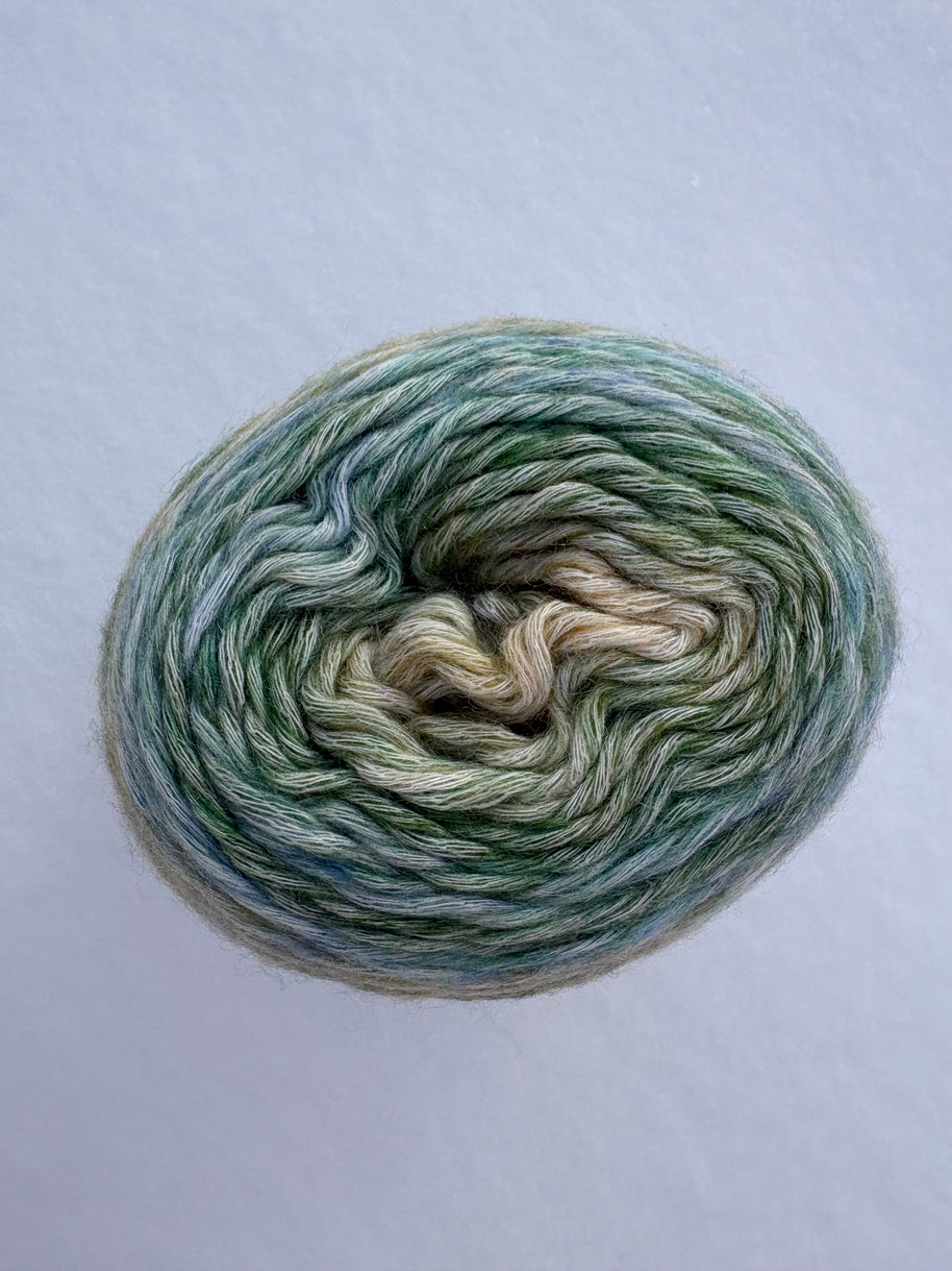 Multicolored yarn skein on a light gray background