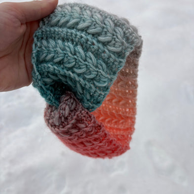 Teal and coral gradient crochet headband with braided stitch texture – Fluffmade Solstice Ear Warmer.