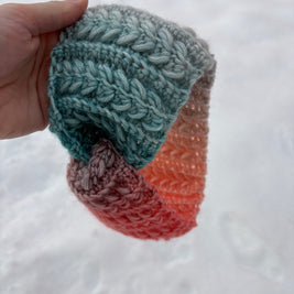 Teal and coral gradient crochet headband with braided stitch texture – Fluffmade Solstice Ear Warmer.