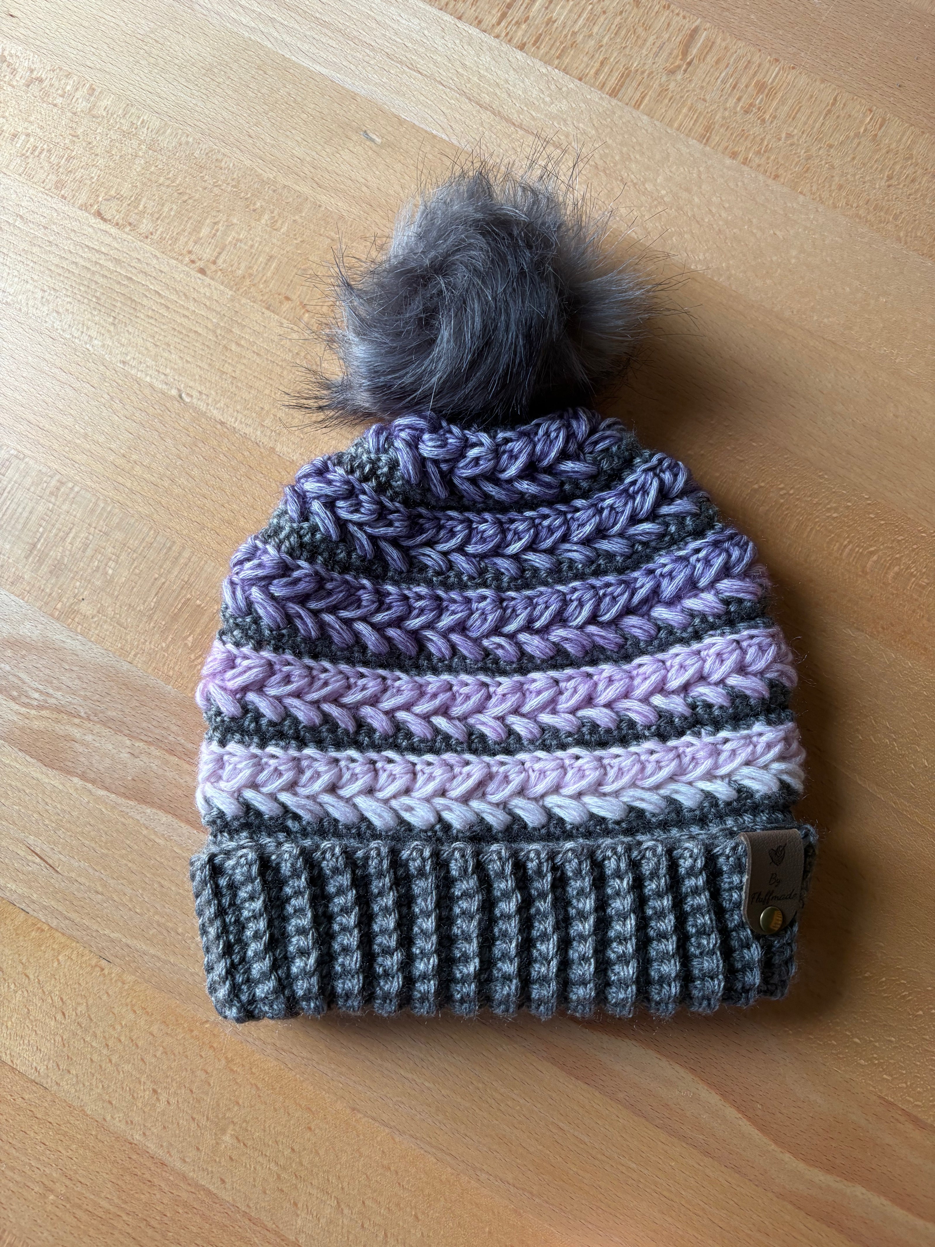 Purple and grey crochet toque with grey faux fur pom and braided texture – handcrafted in Canada.