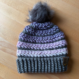 Purple and grey crochet toque with grey faux fur pom and braided texture – handcrafted in Canada.