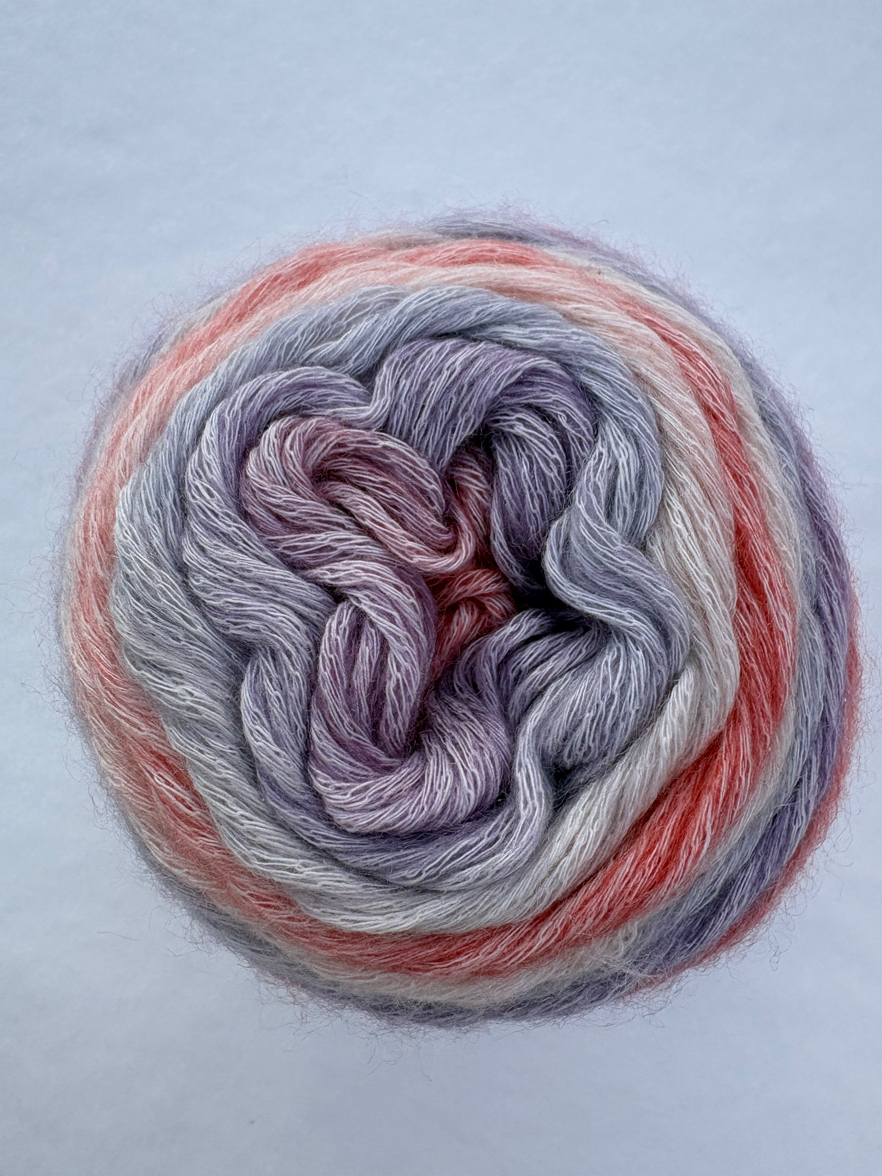 Multicolored yarn skein on a light gray background
