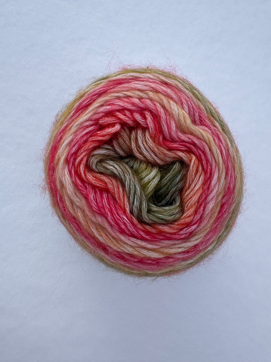 Multicolored yarn ball on a light gray background