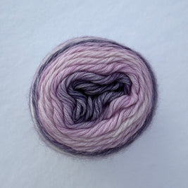 Ball of pink and purple yarn on a light gray background