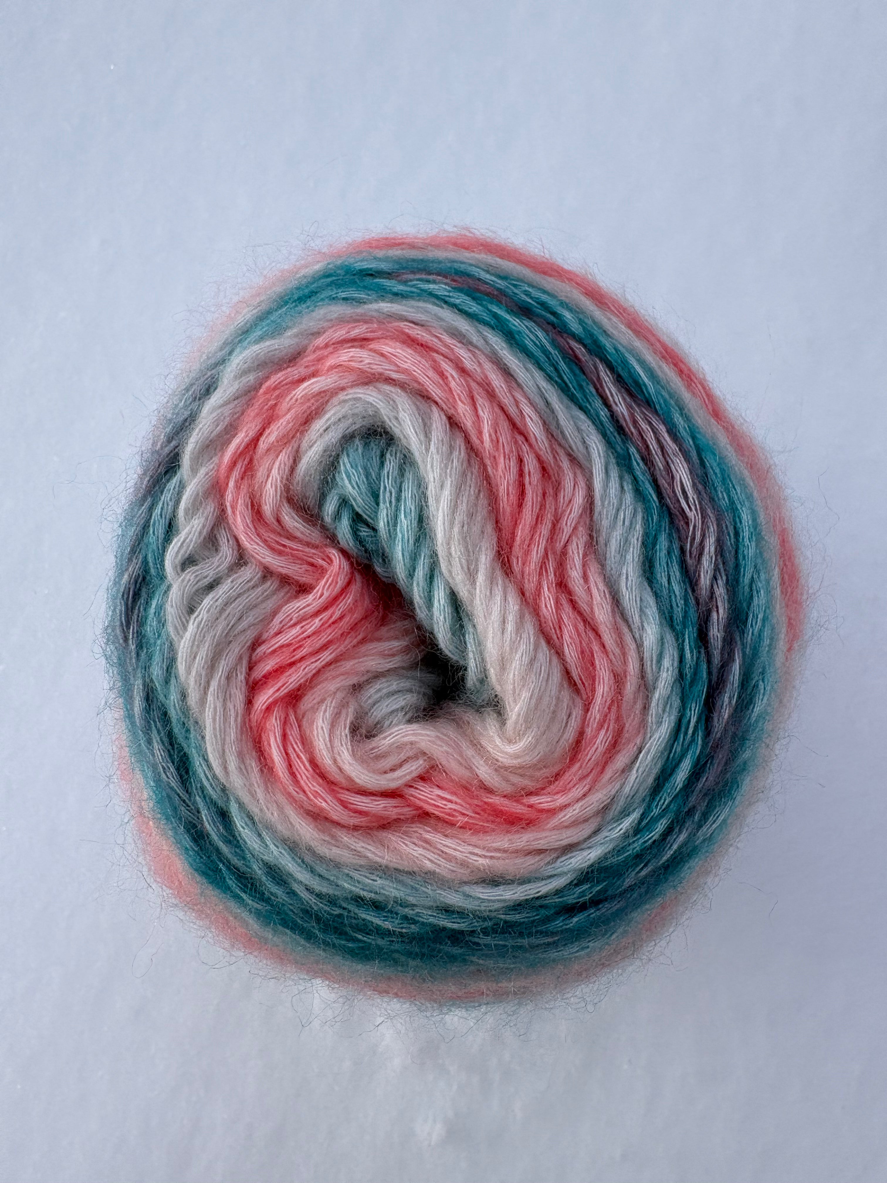 Multicolored yarn skein on a light gray background